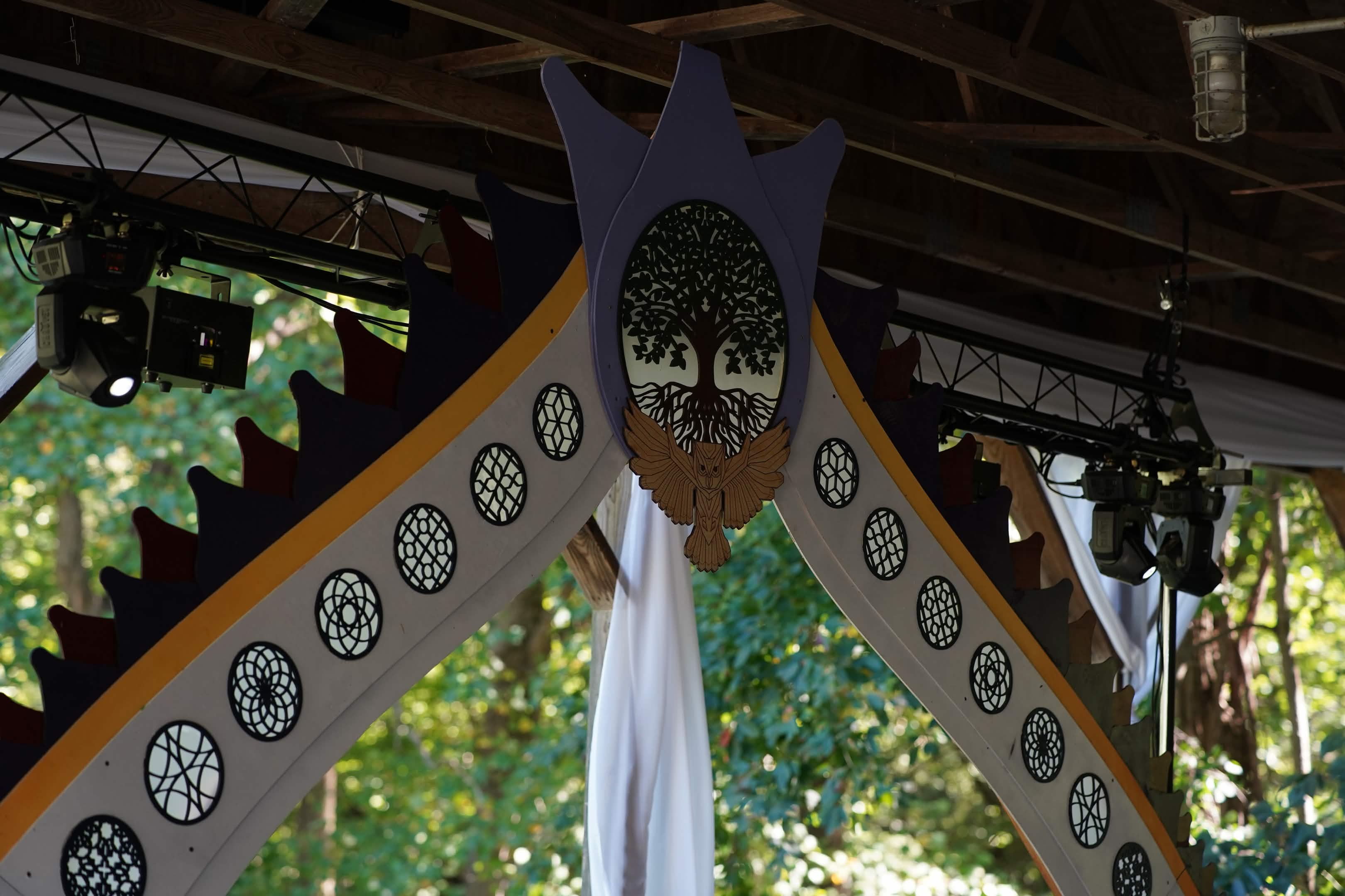 CNC-fabricated sacred geometry stage arch with tree of life and owl - wedding by Aether Immersive