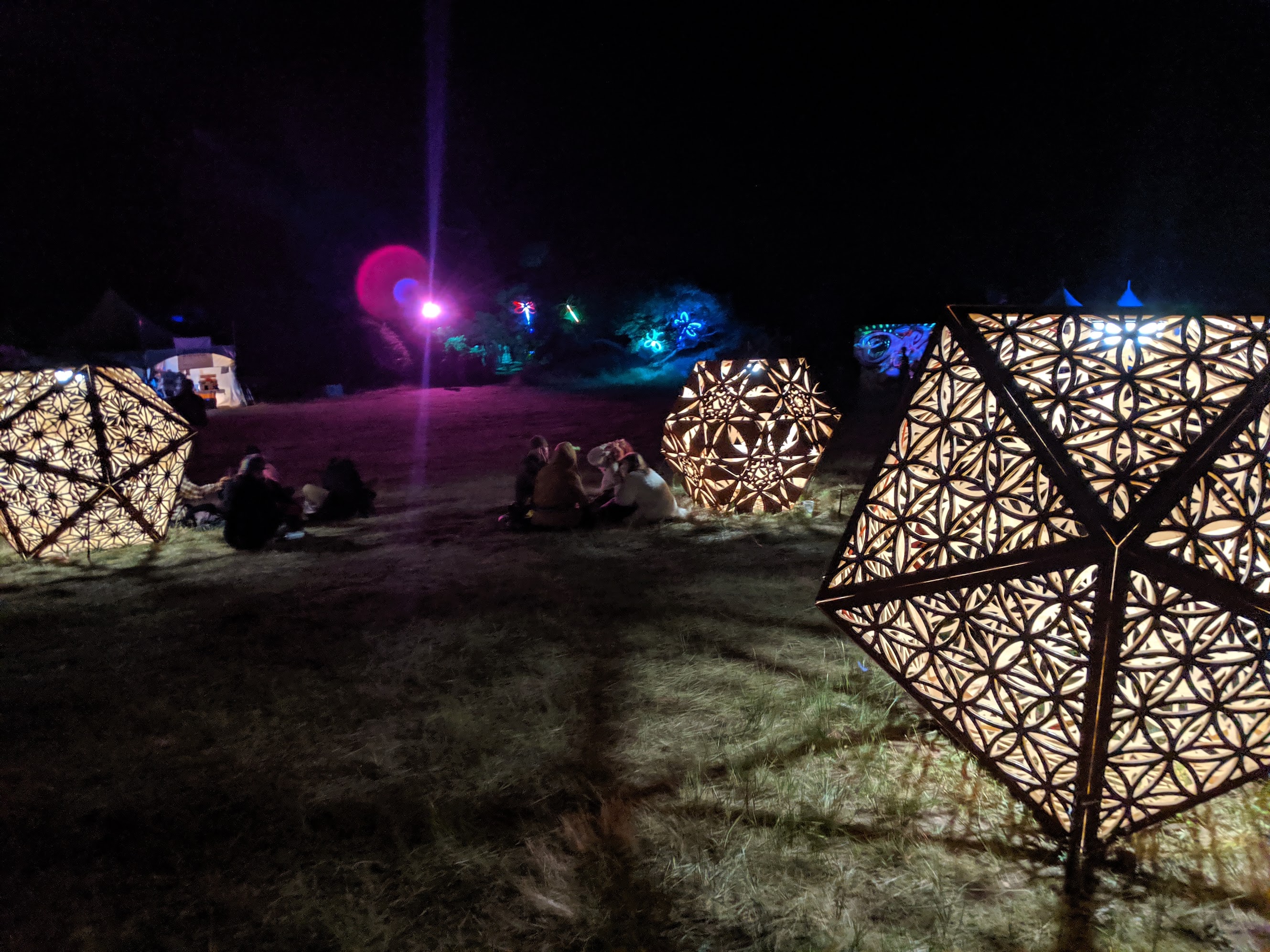 Festival-goers around illuminated lanterns